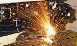 Golden sparks bursting from a welding contact point on a metal workpiece